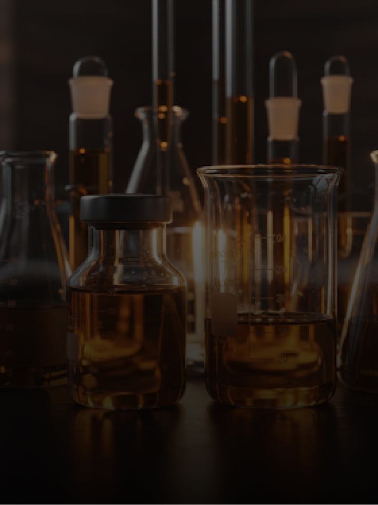 Collection of glass laboratory equipment on a dark background