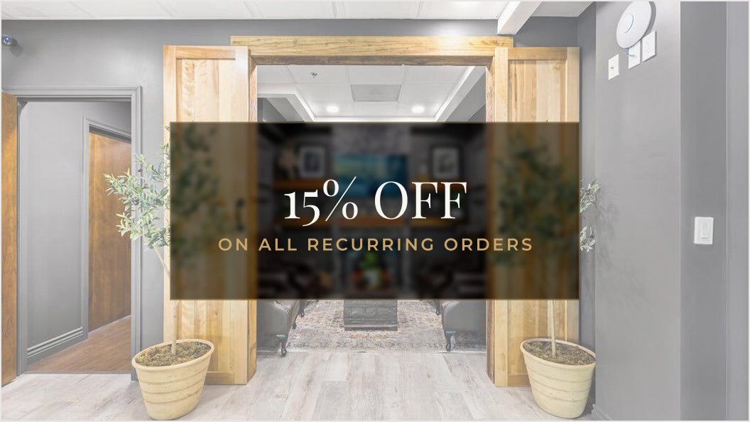 A promotional banner overlay reading '15% OFF ON ALL RECURRING ORDERS' centered over a modern office lobby with light wood doors, gray walls, and potted plants.